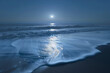 the soft, silky surface of a coastal sea under the moonlight, waves gently lapping the shore
