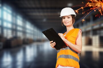 Wall Mural - Mature professional worker at construction site holds clipboard