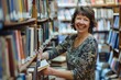 © ChaoticMind - A smiling mature woman enjoying the search for books in a library setting, surrounded by shelves of literature