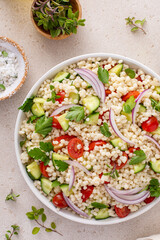 Wall Mural - Pearl couscous salad with fresh vegetables and herbs, healthy side dish idea