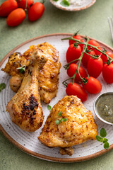 Wall Mural - Roasted chicken drumsticks and thighs with pesto and tomatoes