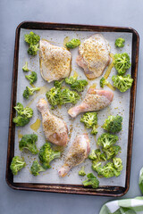 Canvas Print - Chicken drumsticks and thighs with broccoli sheet pan dinner or lunch