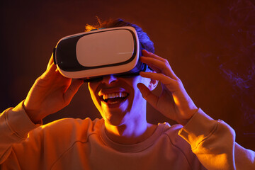 Poster - Young man with virtual reality headset on brown background