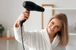 © Pixel-Shot - Pretty young blonde drying hair in bathroom