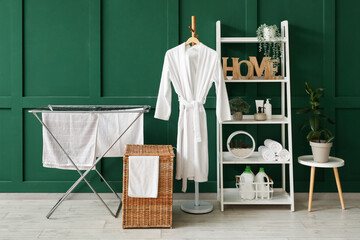 Poster - Interior of room with laundry basket, dryer and shelf unit