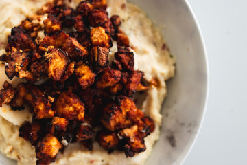 Wall Mural - teriyaki marinated tofu chunks with mashed potato, close-up shot