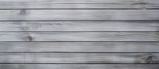 Wall Mural - A closeup of a rectangular grey wooden surface with parallel siding, featuring tints and shades of grey. The texture of the wood creates a subtle pattern in monochrome photography