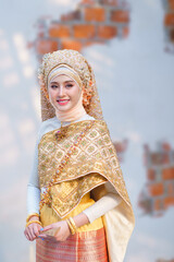 Beautiful bride in traditional Muslim wedding dress applied with luxurious Thai clothing combined blend of two cultures in the Lanna style, Chiang Mai, Thailand.