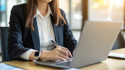 A businesswoman typing on a laptop, she is talking to an employee using a laptop messenger to inquire about company finances. The concept of using technology to assist in communication.