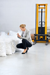 Poster - Factory, business woman and warehouse inspection of raw materials, notes and quality assurance of stock. Writing, planning and female inspector on site, stocktaking and decision on inventory on floor