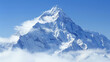 An imposing mountain peak rises majestically, its snow-clad surface gleaming under the bright blue sky