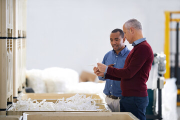 Canvas Print - Factory, communication and warehouse inspection of raw materials and quality assurance of stock. Business people, discussion and diversity on site, collaboration and decision on inventory in shelf