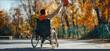 A man in a wheelchair is playing basketball