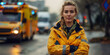 A woman in a yellow jacket stands in front of an ambulance