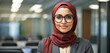 Portrait of muslim woman in office wearing hijab and glasses. Confident beautiful businesswoman at workplace banner