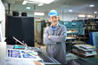 © peopleimages.com - Portrait, confident and manager in warehouse with machine for printing, equipment maintenance and production supervisor. Male person and industrial factory for manufacturing or distribution of paper.