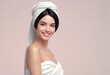 Portrait of a beautiful young woman with a white towel on her head