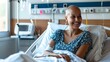 © tashechka - A happy female patient smiling warmly in a bright hospital room setting.