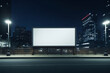 Empty Blank Horizontal Billboard on a City Street at Night, Illuminated with Street Lights, Modern Urban Landscape with Copy Space, Mockup Advertising Concept in a Metropolitan Setting