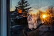 elderly person through window, sunset reflecting off glass
