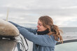 © Cavan Images - Woman removing surf board from roof of car