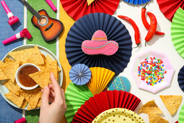 Wall Mural - Nachos in a bowl with sauce and festive decorations