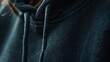 Close-up photo of specific details of the hoodie mockup, such as the fabric texture, stitching, cuffs, or drawstrings