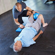© peopleimages.com - Physiotherapist, helping and senior man with arthritis, training and elderly support for care. Men, gym and exercise for health, wellness and coaching with medical ball for mature rehab and wellbeing