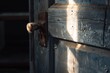 sunlight shining on a dusty, neglected door handle