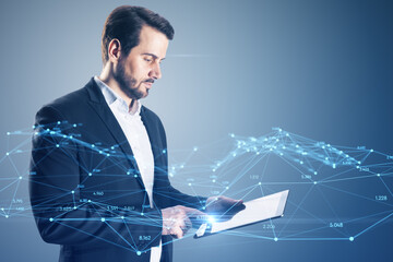 Wall Mural - Attractive young european businessman using tablet with creative glowing polygonal interface on blurry background. Technology, innovation and network concept.