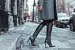 woman in tailored coat and sleek leather boots on urban sidewalk
