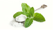 A sprig of fresh mint and a spoon of powdered sugar for garnishing a Mint Julep, isolated on a white background 