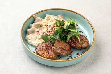 Wall Mural - Portion of beef medallions and garnish with mushrooms