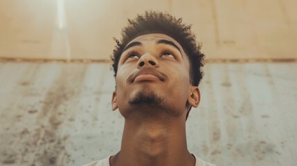 Wall Mural - A young man looks up in the distance