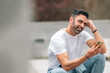© carballo - attractive young adult man with beard outdoors chatting smiling with mobile phone