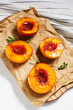 Baked peaches with honey and cinnamon on white wooden background. summer dessert.
