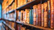 The blurred image of many old books on a library shelf captures the essence of a world filled with stories and knowledge waiting to be discovered