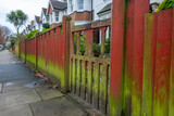 Fototapeta Londyn - Fence on UK residential fence with green algae