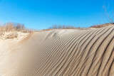 Fototapeta Boho - Sand dune against the blue sky. Beautiful coastal landscape.