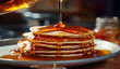 Pancakes drizzled with flavorful honey on a neutral background.