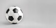 black and white soccer ball or football on gray background with copy space