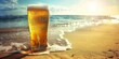 A glass of beer is sitting on the sand at the beach