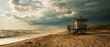 A lone lifeguard tower stands guard over a deserted beach, with