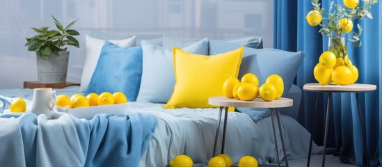 A small and cozy living room featuring blue and yellow decor. The room is tastefully designed with modern furniture, complemented by yellow accents such as lemons on the table.