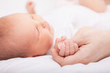 Fototapeta  - Newborn Baby Asleep Holding Mother
