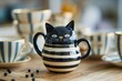 a black and white cat shaped teapot