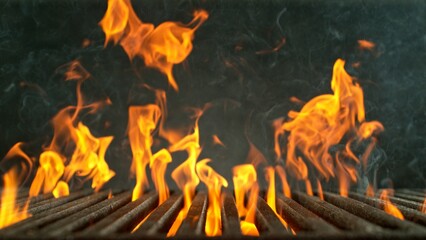 Wall Mural - Close-up of cast-iron grate with fire flames, dark background