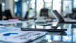© Radomir Jovanovic - Close-up of a smartphone lying on a business desk, surrounded by graphs and a laptop, depicting office work