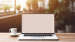 © Synthetica - Laptop with blank screen and coffee cup on wooden table in cafe