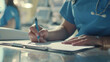 Healthcare professional writing notes, focused in a medical environment.
